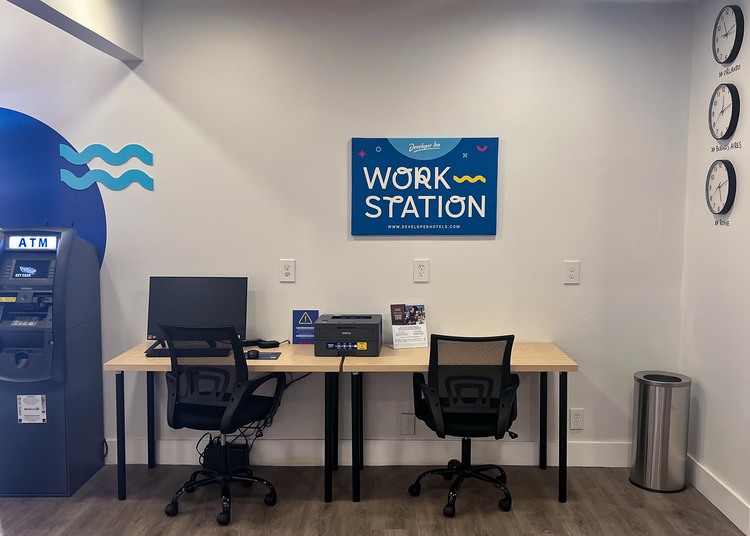 Desk with computer next to ATM machine